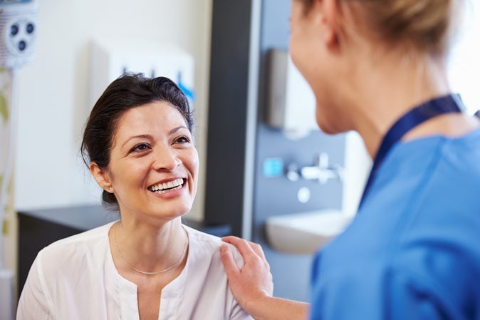 Female patient being reassured by doctor