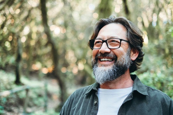Man with beard smiling outdoors
